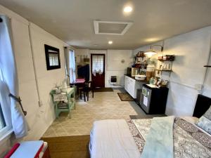 a bedroom with a bed and a kitchen with a table at "Lovely Tiny House Rental for a Romantic Getaway in Shepherdstown, West Virginia in Shepherdstown