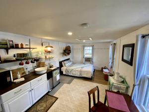 a kitchen and a bedroom with a bed in a room at "Lovely Tiny House Rental for a Romantic Getaway in Shepherdstown, West Virginia in Shepherdstown