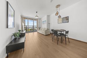 a dining room and living room with a table and chairs at The first skyscraper in Slovakia in Bratislava