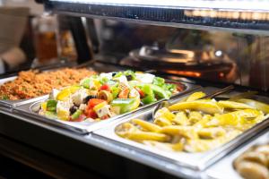 a buffet with many different types of food on trays at O&O Hotel Oberursel Zentrum in Oberursel