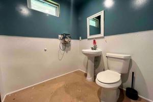 a bathroom with a toilet and a window at Secluded Riverside Cabin for 8 in Belfast, NY with Rustic Amish-Built Retreat in Oramel