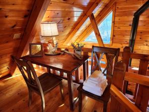a dining room table and chairs in a cabin at Charming Creekside Log Cabin with Wood Burning Stove Overlooking the Neshannock Creek, Western PA in Volant +61 photos