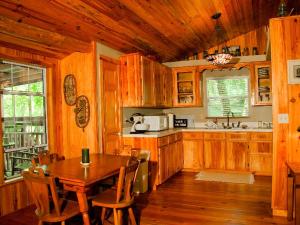 a kitchen with wooden cabinets and a table in a kitchen at Rustic Cabin on a Ranch near the Ocala National Forest in Central Florida in Fort McCoy +7 photos