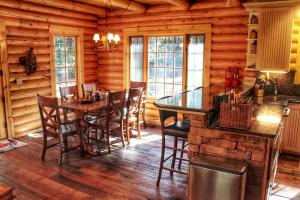 a dining room with a table and chairs in a cabin at Family-Friendly Log Cabin Rental in California's Gold Country near Sacramento in Barton +12 photos