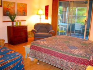 a bedroom with a bed and a chair and a dresser at Stately 20-Person Beach Vacation Rental on the Shores of Lake Michigan near Muskegon, Michigan in Montague