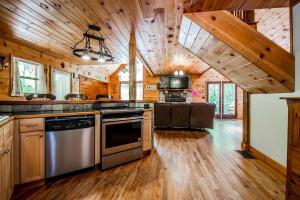 a large kitchen with wooden floors and wooden ceilings at Gorgeous Cabin with Pool Table, Fire Pit and Hot-tub in Cleveland, Georgia in Kinseytown