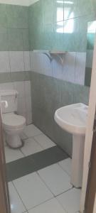 a bathroom with a toilet and a sink at Mawingo Appartments in Mombasa