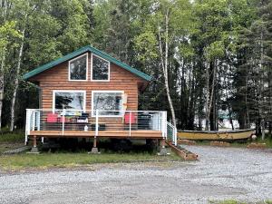 a log cabin with a large window on the front at Spacious Waterfront Cabin Rental on the Shores of Cook Inlet, Alaska in Kasilof
