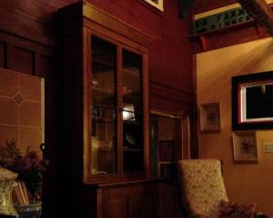 a living room with a cabinet and a chair at Delightful Guest House Cabin in the Adirondacks in North River +15 photos