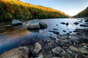 a river with some rocks in the water at Delightful Guest House Cabin in the Adirondacks in North River