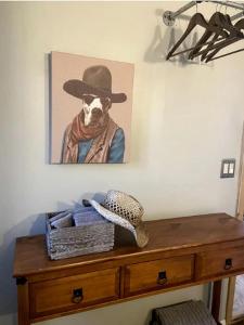 a picture of a dog wearing a hat on a dresser at Charming Yucca Valley Cabin Rental for Getaways in California in Yucca Valley