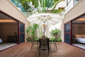 a patio with a table and chairs and a chandelier at Sanya Haitang Bay Renguan Sea View Pool Villa (Water World Duty Free City Store) in Sanya +86 photos