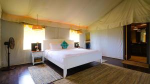 a bedroom with a white bed in a tent at SerenityRetreat  +76 photos