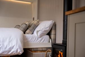 a bedroom with a bed and a fireplace at Driftwood with Hot Tub in Corpach