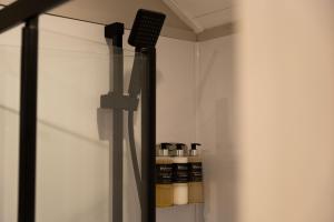 a room with a glass door with bottles in it at Driftwood with Hot Tub in Corpach