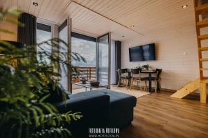 a living room with a couch and a table at Chillzone u Grochów in Bieniowice
