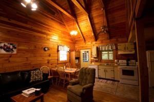 a living room with a table and chairs in a cabin at Spacious Cabin Rental with a Hot Tub near the Gauley River in West Virginia in Hico