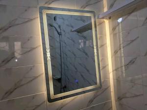 a mirror on a wall in a room at 1 chambre salon a godomey in Ouéto