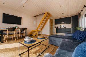a living room with a couch and a table at Chillzone u Grochów in Bieniowice