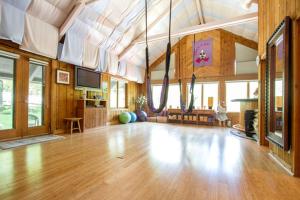 a large room with a wooden floor and a living room at Bed and Breakfast Ski Chalet with Yoga Studio in Stratton Mountain, Vermont in Stratton Mountain