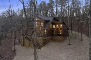 a log cabin in the woods with trees at Beautiful Log Cabin with Private Hot Tub, Fire Pit, and Spacious Balcony, Perfect for a Luxury Mountain Retreat in Mount Herman