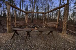two chairs and a fire pit in the woods at Beautiful Log Cabin with Private Hot Tub, Fire Pit, and Spacious Balcony, Perfect for a Luxury Mountain Retreat in Mount Herman +38 photos