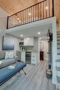 a living room with a couch and a kitchen at Lofted Romantic Tree House Immersed in Nature in Alabama in Grant