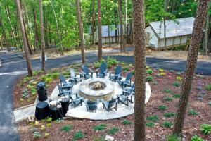 a fire pit in the middle of a forest at Lofted Romantic Tree House Immersed in Nature in Alabama in Grant