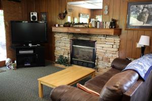 a living room with a couch and a fireplace at Rustic Family Cabin Rental with a Fire Pit near Wisconsin Dells in Tomah +26 photos