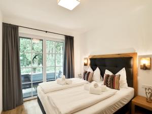 two beds in a hotel room with a window at Chalet in Krimml near Zillertal Ski Arena in Krimml
