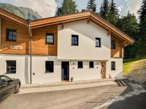 a house in the mountains with a car parked in front at Chalet in Krimml near Zillertal Ski Arena in Krimml