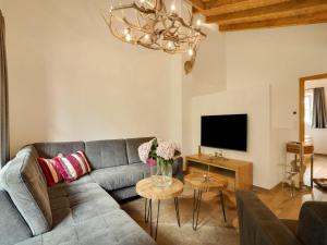 a living room with a couch and a tv at Chalet in Krimml near Zillertal Ski Arena in Krimml +32 photos