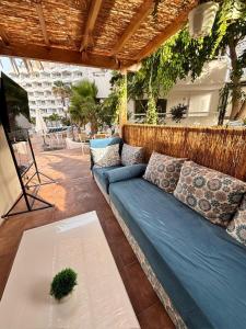 a blue couch on a patio with a table at Costa Dreams Costa Adeje in Costa de Adeje