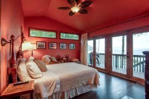 a bedroom with a bed and a ceiling fan at Dog Friendly Cabin on Lake Pend O'reille with Hot Tub and Lakefront Views, Perfect for a Family Retreat on the Lake in Broten
