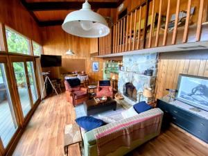 an overhead view of a living room with a stone fireplace at Dog Friendly Cabin on Lake Pend O'reille with Hot Tub and Lakefront Views, Perfect for a Family Retreat on the Lake in Broten
