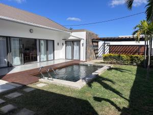 a swimming pool in the backyard of a house at The Royal Vista by SOV in Grand-Baie