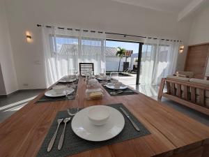 a dining room table with plates and glasses on it at The Royal Vista by SOV in Grand-Baie
