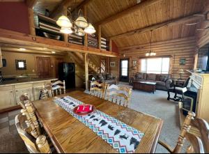 a dining room and living room in a log cabin at Secluded Montana Cabin with Stunning Madison River Valley Views, Near Ennis, MT in Virginia City