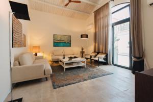 a living room with a couch and a table at Dimora Crocefisso in Noto