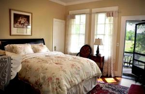 a bedroom with a bed and a window at Luxurious Bed and Breakfast Vacation Rental for Large Groups in East Texas in Zavalla