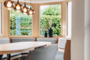 a dining room with a table and chairs and a window at Chalet-Midl in Umhausen +12 photos