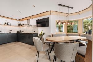 a kitchen and dining room with a table and chairs at Chalet-Midl in Umhausen