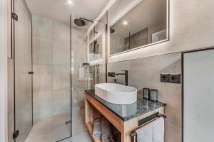 a bathroom with a sink and a shower at Chalet-Midl in Umhausen
