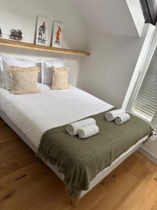 a bedroom with a bed with towels on it at T3 CENTRE VILLE 2ème étage in Angers