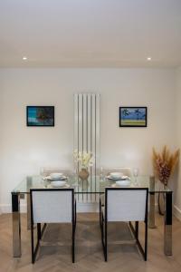ハットフィールドにあるHatfield Haven with Free Parking, 25min London and Fast Wi-Fiのダイニングルーム(ガラステーブル、椅子2脚付)