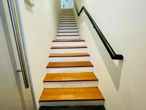a stairway with wooden steps and a railing at Heritage Collection on Ann Siang - Mobile App Check-In in Singapore