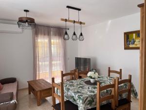a kitchen and dining room with a table and chairs at Casa Sol y Valle in Sotillo de la Adrada