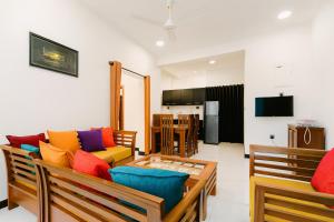 a living room with a couch and a table at ACCOM Premium Residence in Gangodawila
