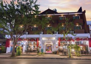 an exterior view of a hotel at night at The Experience Walking Street Chiang Mai in Chiang Mai