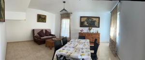 a living room with a table and a couch at Casa Sol y Valle in Sotillo de la Adrada